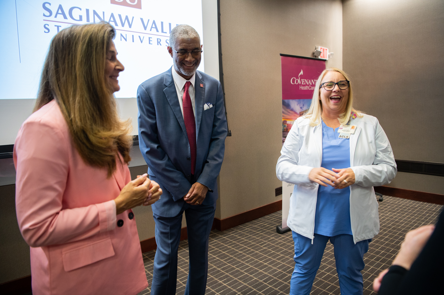 two women and  a man share a laugh